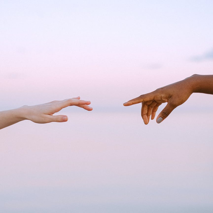 Photo Of People Reaching Each Other's Hands